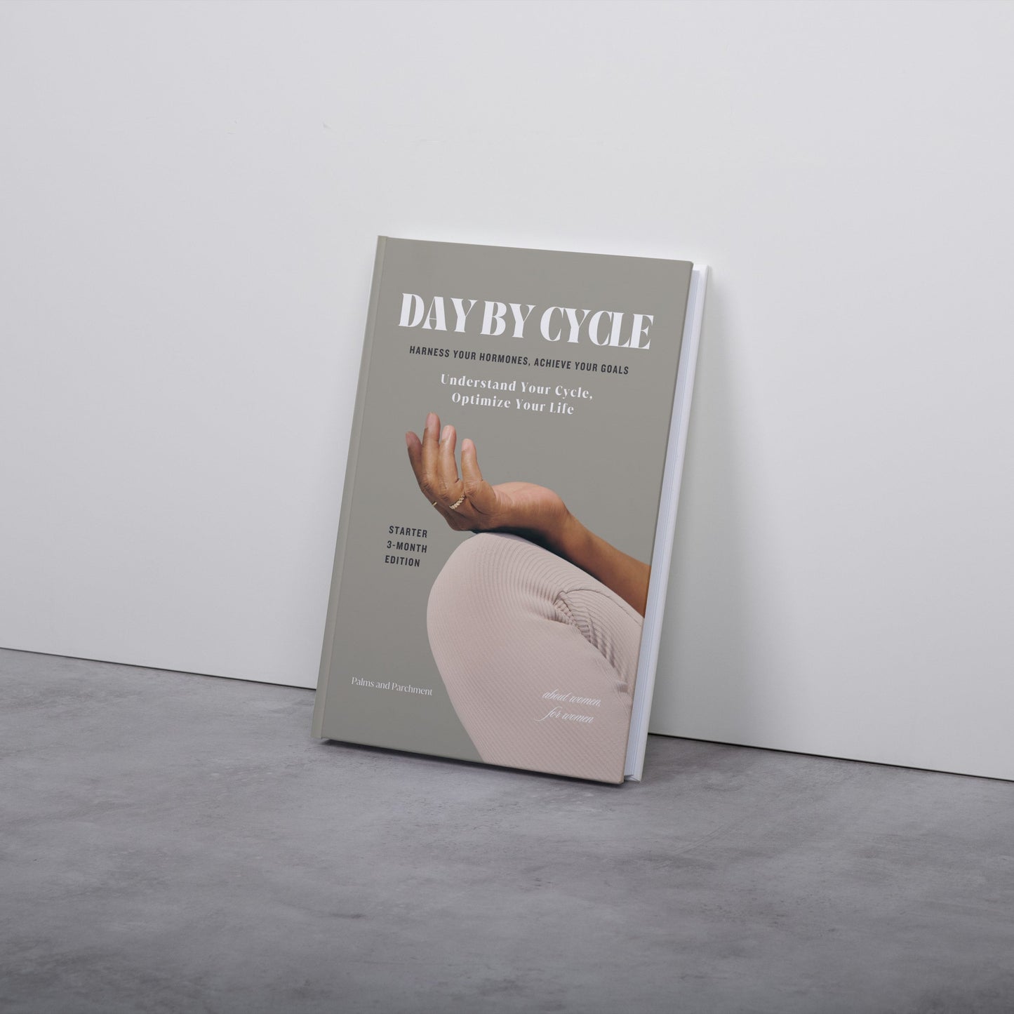 Book titled 'Day by Cycle' on a gray surface with a white background
